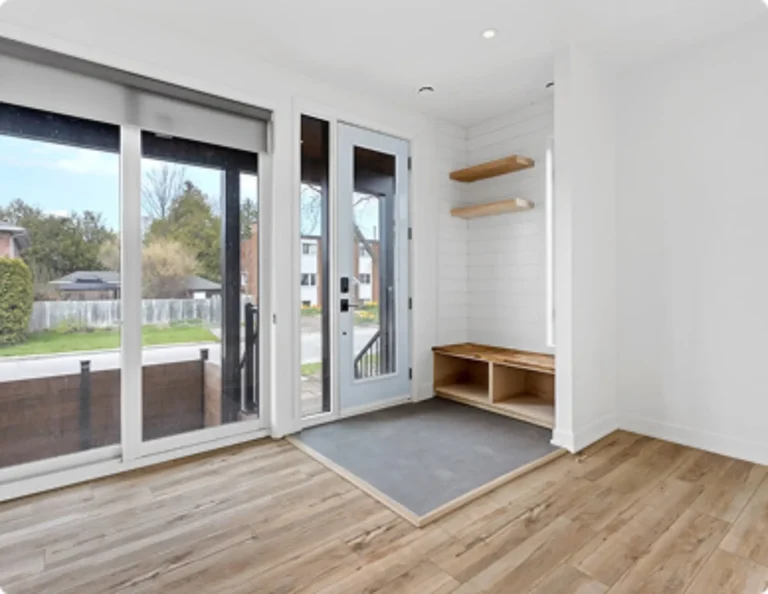 Modern white-framed windows overlooking a residential garden