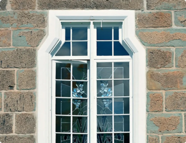 White-framed window installed in a stone exterior wall